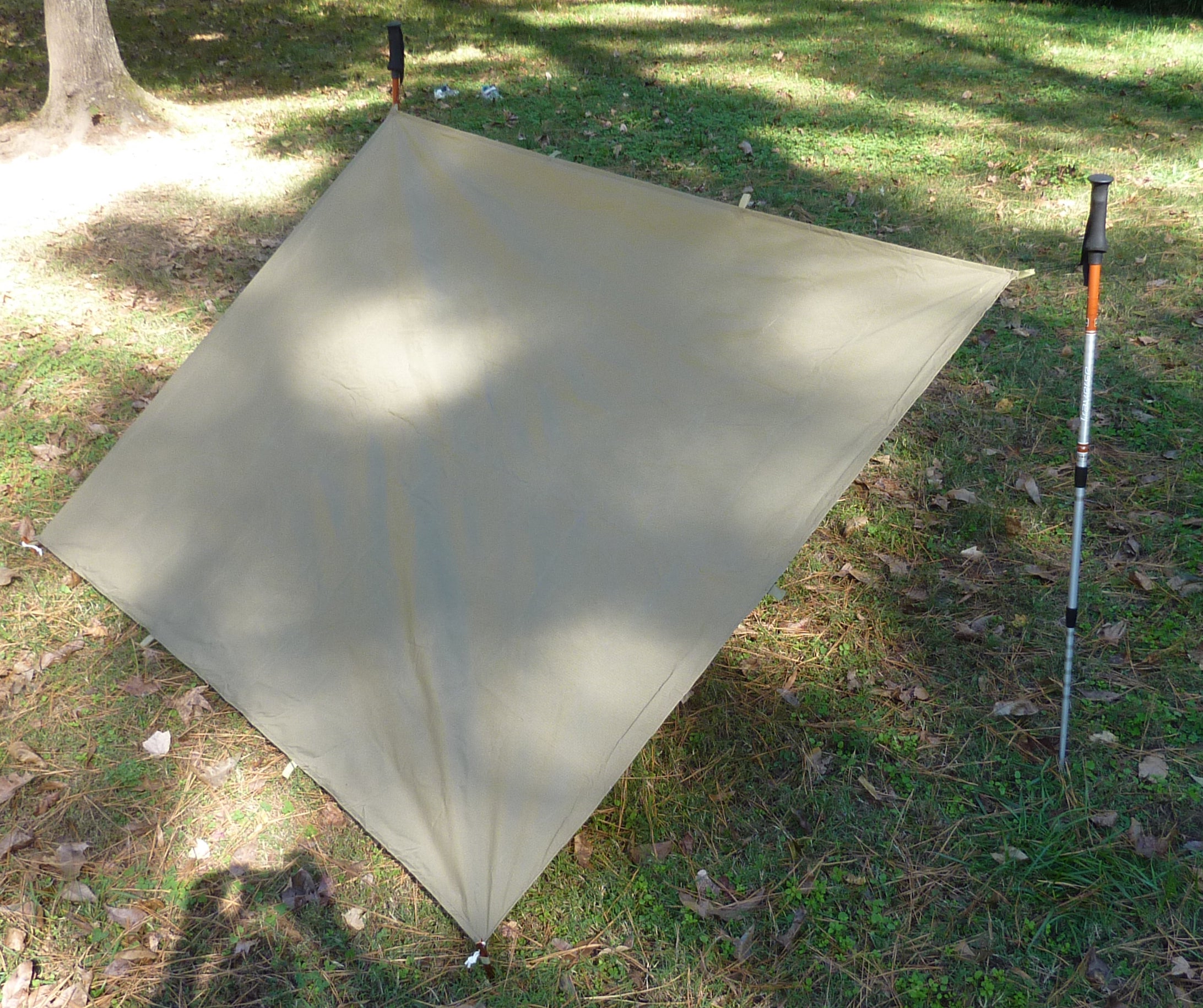Coyote Brown Tarp Shelter setup with trek poles
