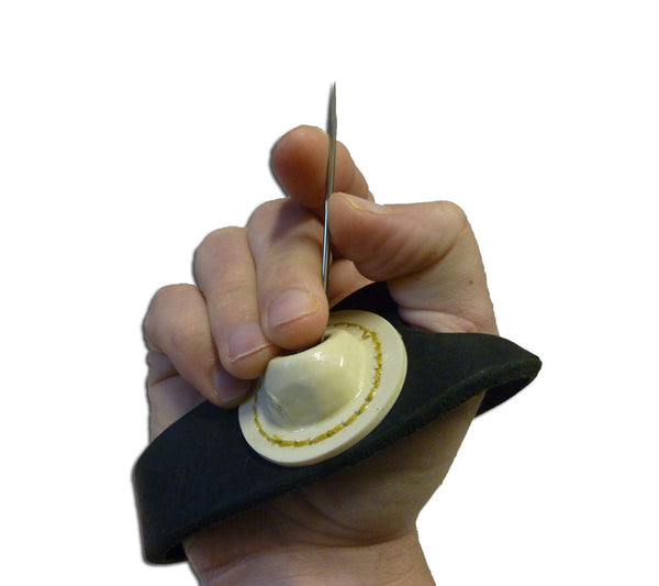 Demonstration of the sewing palm being used with a needle.